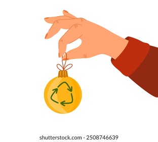 Green Christmas concept. Vector eco-friendly sustainable illustration. The human hand holds a green Xmas toy with a recycling symbol.
