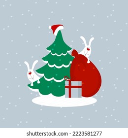 A green christmas tree with santa claus hat, red bag, gift box and two cute happy smiling white bunnies or hares peeking out from behind a tree. Editable flat style vector illustration
