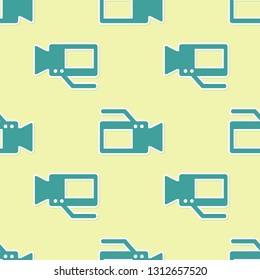 Green Cinema camera icon isolated seamless pattern on yellow background. Video camera. Movie sign. Film projector. Flat design. Vector Illustration