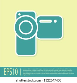 Green Cinema camera icon isolated on yellow background. Video camera. Movie sign. Film projector. Flat design. Vector Illustration