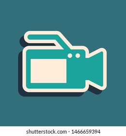 Green Cinema camera icon isolated on blue background. Video camera. Movie sign. Film projector. Long shadow style. Vector Illustration
