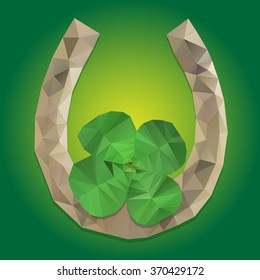 Green clover and horseshoe on a green background. polygonal stylization 