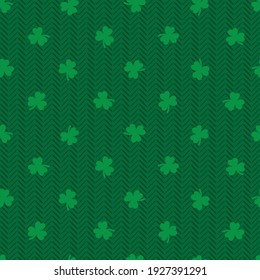 Green clover on herringbone fabric texture seamless pattern on green background. St Patrick's day vector illustration.