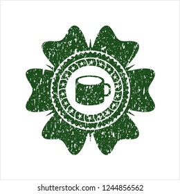 Green coffee cup icon inside distressed rubber grunge seal