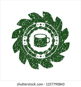 Green coffee cup icon inside distress rubber grunge seal