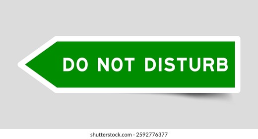Green color arrow shape sticker label with word do not disturb on gray background