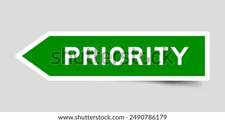 Green color arrow shape sticker label with word priority on gray background