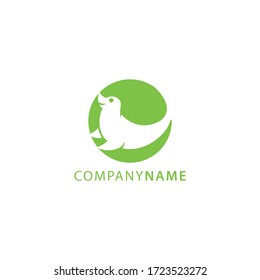 Green color silhouette of sea lion animal logo inside circle shape in negative style technique design vector illustration
