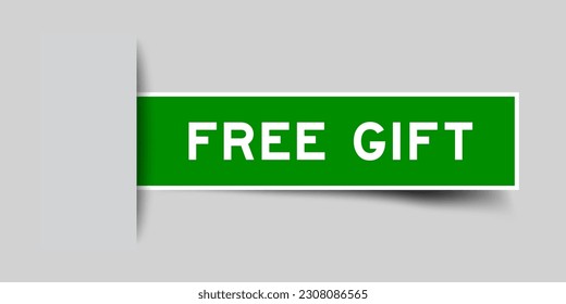 Green color square label sticker with word free gift that inserted in gray background