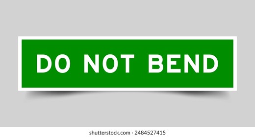Green color square label sticker with word do not bend that inserted in gray background