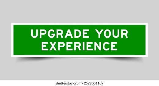 Green color square shape sticker label with word upgrade your experience on gray background