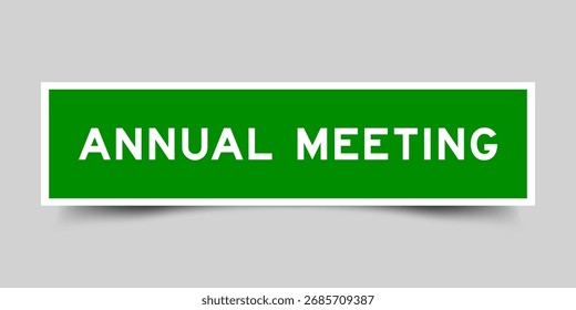 Green color square shape sticker label with word annual meeting on gray background