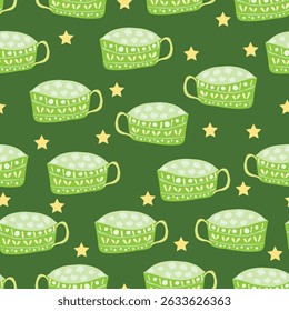 green colored decorated clay mugs with intricate glaze and stars on green background seamless pattern. green playful cups with yellow stars placed on dark green background seamless pattern. 