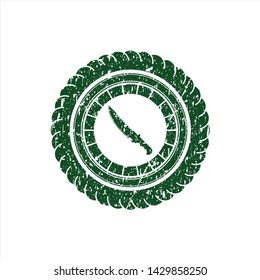 Green combat knife icon inside distressed grunge style stamp