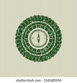 Green compass icon inside distress rubber grunge seal