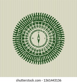 Green compass icon inside rubber stamp with grunge texture