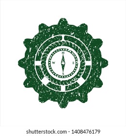 Green compass icon inside rubber grunge stamp