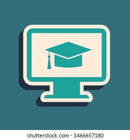Green Computer monitor with graduation cap icon isolated on blue background. Online learning or e-learning concept. Internet knowledge symbol. Long shadow style. Vector Illustration