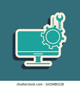 Green Computer monitor with screwdriver and wrench icon isolated on blue background. Adjusting, service, setting, maintenance, repair. Long shadow style. Vector Illustration