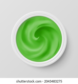 Crema de cosméticos verdes en la vista superior del contenedor de paquetes. Producto cosmético para el cuidado de la cara de la piel. Aplicable a productos lácteos