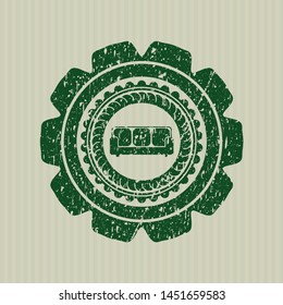 Green couch icon inside distress rubber grunge stamp
