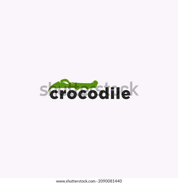 green crocodile logo\
negative space
