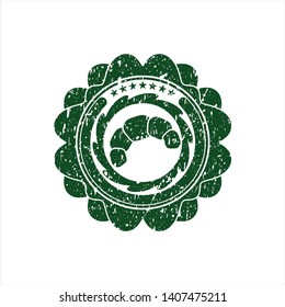 Green croissant icon inside distress rubber seal