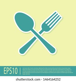 Green Crossed fork and spoon icon isolated on yellow background. Cooking utensil. Cutlery sign.  Vector Illustration
