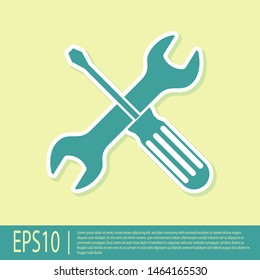 Green Crossed screwdriver and wrench tools icon isolated on yellow background. Service tool symbol.  Vector Illustration
