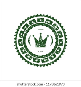 Green crown icon inside rubber grunge stamp