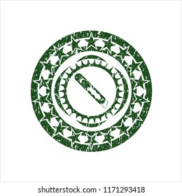 Green cutter icon inside grunge style stamp