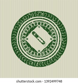 Green cutter icon inside rubber stamp