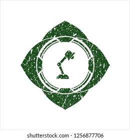 Green desk lamp icon inside distress rubber seal