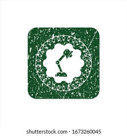 Green desk lamp icon inside distressed grunge style stamp