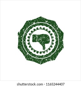 Green dislike icon inside distressed rubber grunge texture stamp
