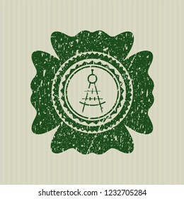 Green drawing compass icon inside distressed grunge stamp