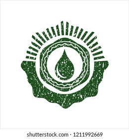 Green drop icon inside distressed rubber stamp
