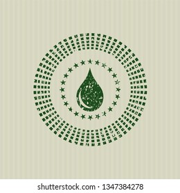 Green drop icon inside distressed rubber grunge texture seal
