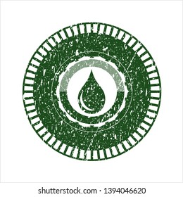Green drop icon inside distressed rubber grunge texture stamp