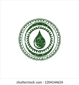 Green drop icon inside grunge seal