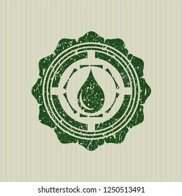 Green drop icon inside grunge style stamp