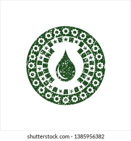 Green drop icon inside rubber grunge stamp