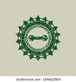 Green dumbbell icon inside distressed grunge stamp