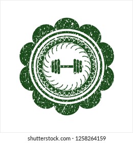 Green dumbbell icon inside grunge seal