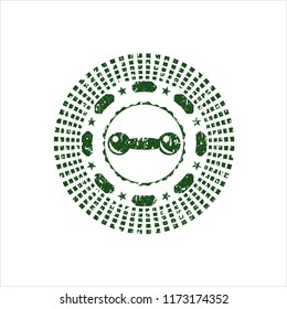 Green dumbbell icon inside rubber stamp with grunge texture