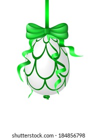 Green easter egg hanging on a ribbon