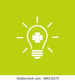 Green electric light bulb with white clover leaf and rays.  Isolated on green. Flat icon. Vector illustration. Eco symbol. Alternative energy logo. Go green. Eco friendly.