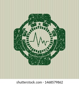Green electrocardiogram icon inside distress rubber seal with grunge texture