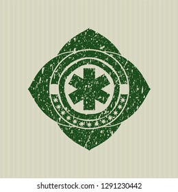 Green emergency cross icon inside rubber stamp