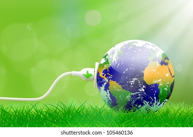 Green energy concept with Planet Earth and electric plug on lush grass